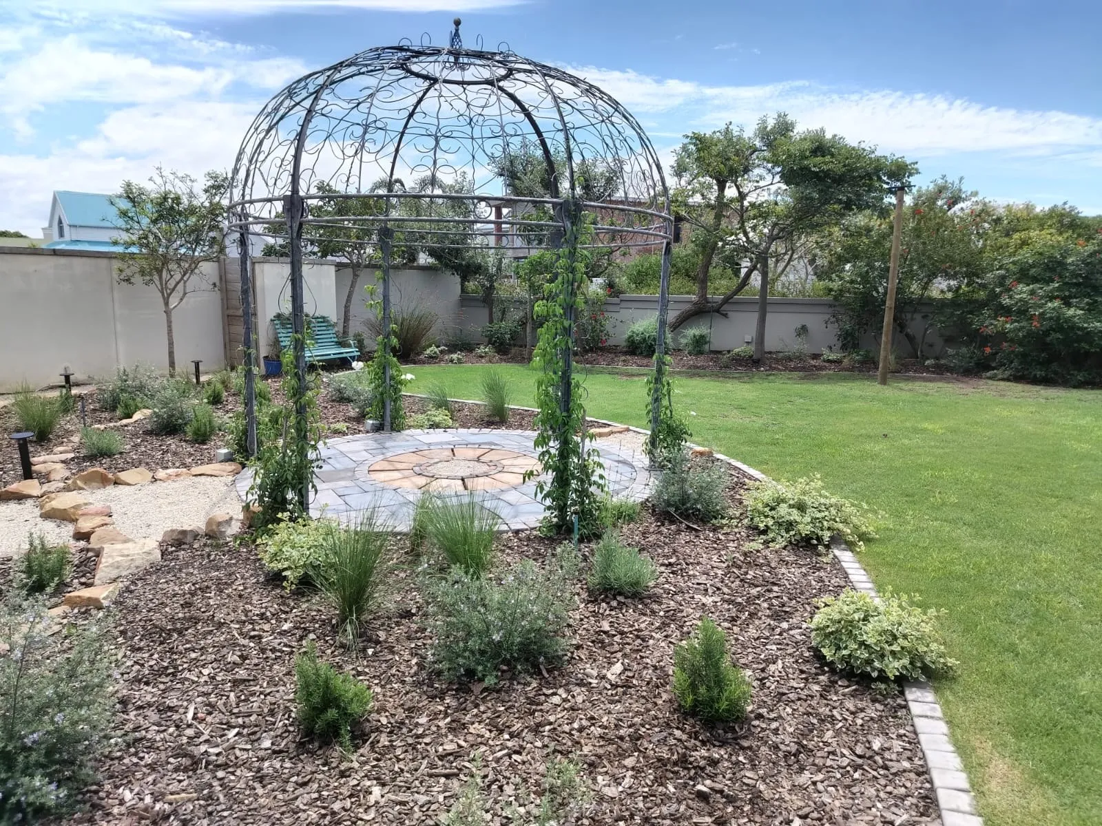 The finished garden with the gazebo, lawn and planted beds