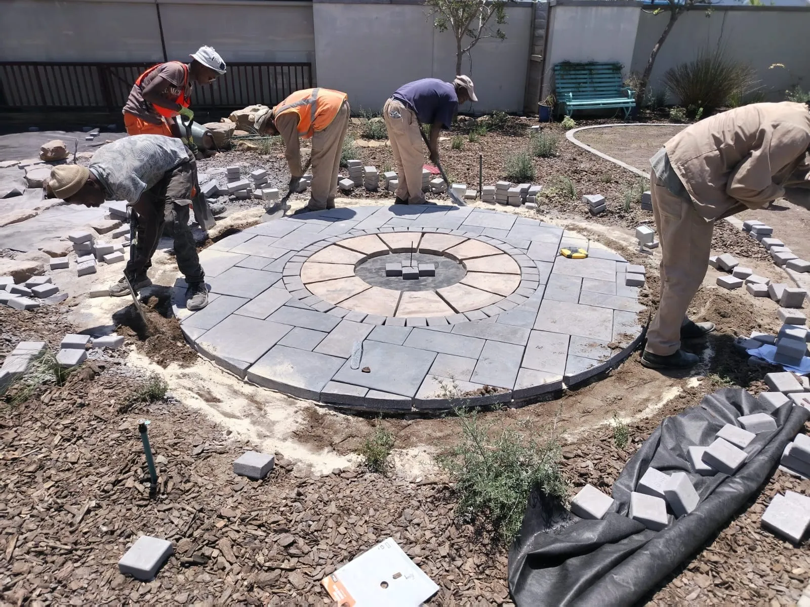 The BenTuin team laying a round paved feature in a Jeffreys Bay garden