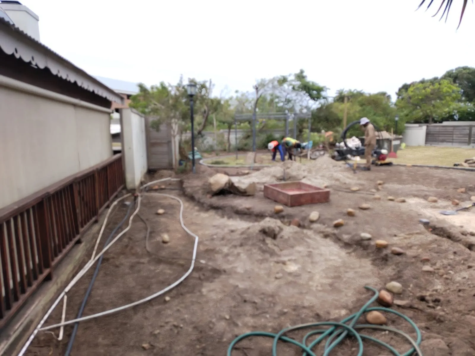 Irrigation pipes laid out across a garden being prepared for planting